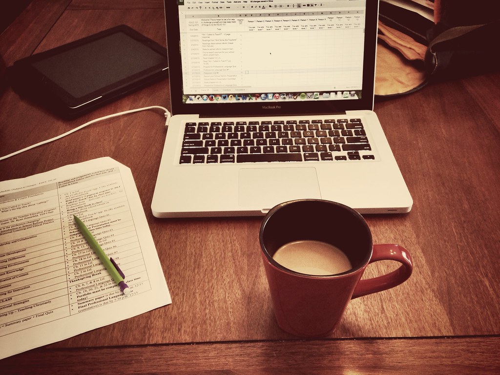 Laptop and coffee on a home desk used for managing accounts online